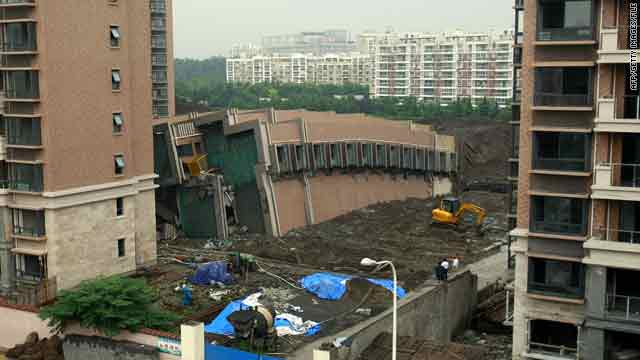 A 13-story residential building under construction in Shanghai lies on the ground after collapsing on June 27, 2009.