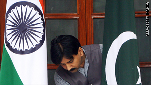 A worker adjusts the Pakistan and India flags prior to a meeting between the neighbors in 2008.