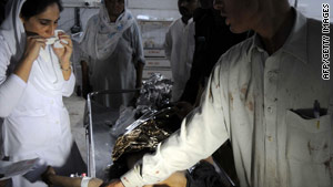 Medical staff at a hospital in Peshawar treat a victim of the bomb atttack at a madrasa.