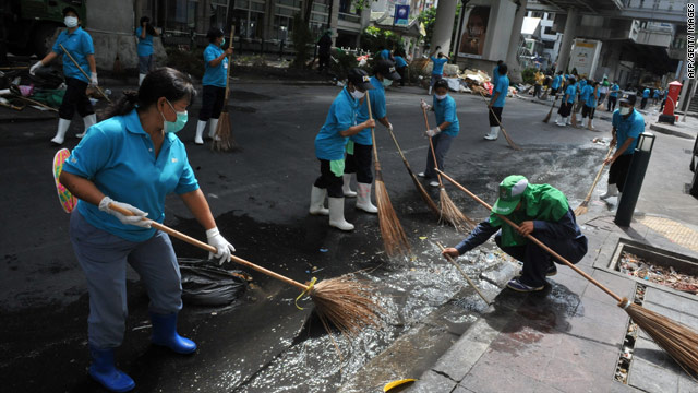 Workers and volunteers clean up downtown Bangkok on Sunday.