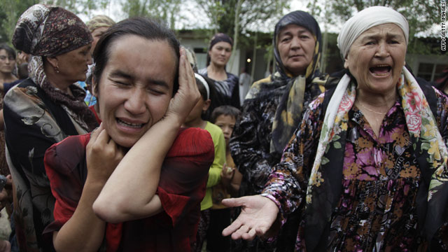 Ethnic Uzbek women plea for help at a refugee camp outside of Osh on Tuesday.