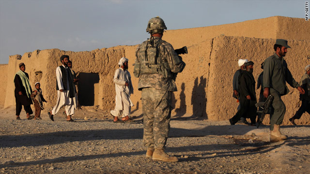 Civilians leave a street in Kandahar City, Afghanistan, on June 14 during a U.S. Army operation.