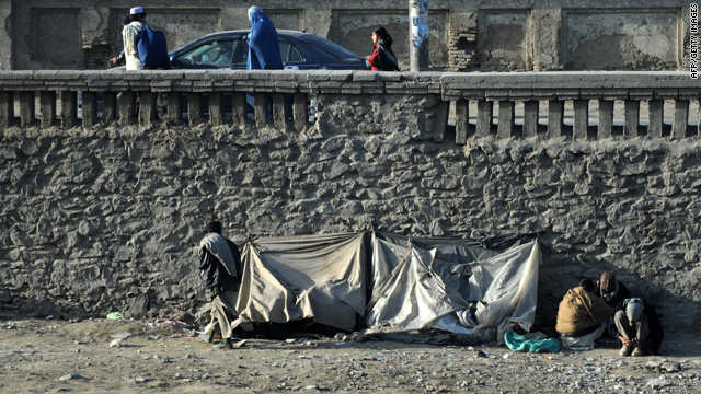 Afghan drug addicts sit in the sun at the Kabul River in Kabul on February 1, 2010.