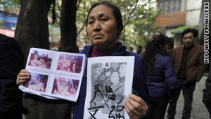 A petitioner outside the Chongqing, China, court in April shows photos of crimes allegedly committed by Wen Qiang.