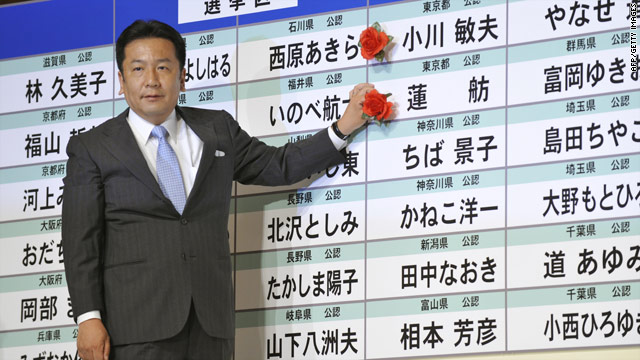 Yukio Edano, DPJ Secretary General, puts a victory rose on the DPJ candidate list at the party's campaign headquarters on July 11, 2010.