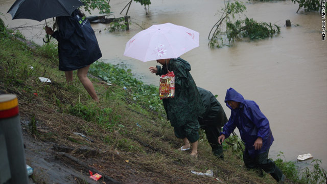 Residents escape a flooded area Luozhen township, China, last month.