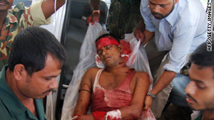 An injured reserve police officer arrives at a hospital Friday in India's Assam state.