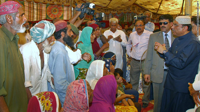 Pakistan president Asif Ali Zardari talks to flood survivors during a visit to a relief camp in Sukkur on August 12, 2010.