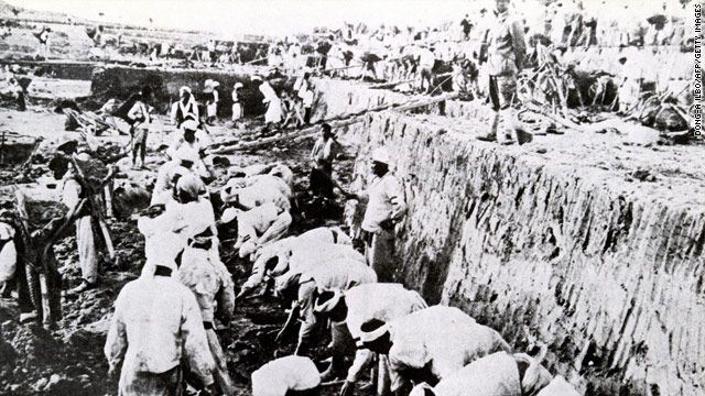 A photo from 1937 shows Koreans working in a gold mine under the watchful eye of Japanese soldiers.