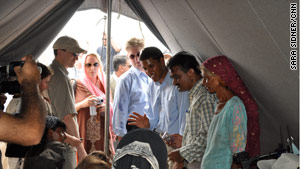 Rajiv Shah, third from right, visited two relief camps in Pakistan to get an idea of flood victims' needs.