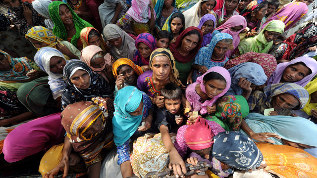 Internally displaced Pakistani women wait for relief goods in Larkana on September 3. Relief efforts in flood-ravaged Pakistan are being stretched by the 'unprecedented scale' of the disaster.