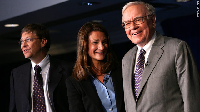 Bill Gates, left, his wife Melinda, and Warren Buffett in this file photo from 2006 shortly after both men both pledged to donate their wealth to charity.