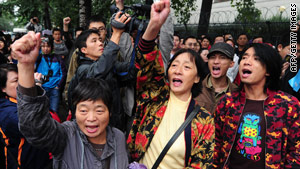 A crowd protests against the fishing boat captain's detention outside the Japanese embassy in Beijing on Saturday.