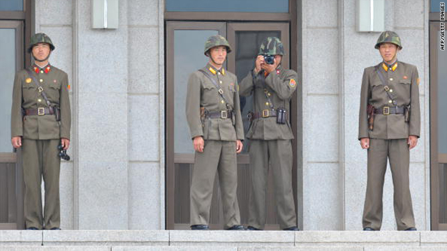 A North Korean soldier takes picture of the southern side of the cross-border village of Panmunjeom on July 27.