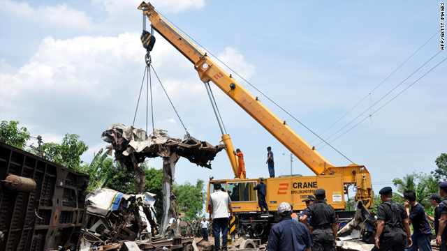 Indonesian officials use heavy equipment to clear debris in the aftermath of the train collison Saturday.
