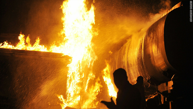 Firefighters try to extinguish burning NATO supply oil tankers after an attack outside Islamabad, Pakistan, Monday.