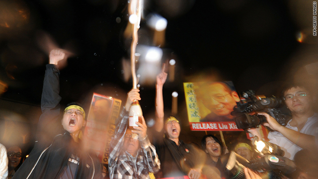 Protestors celebrate Liu Xiaobo's Nobel Peace Prize near the China Liaison Office in Hong Kong on Friday.