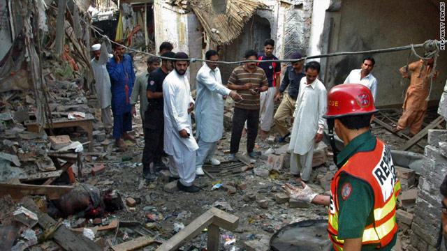 Pakistani security officials inspect the site of the blast near the Sufi shrine in Pakpattan.