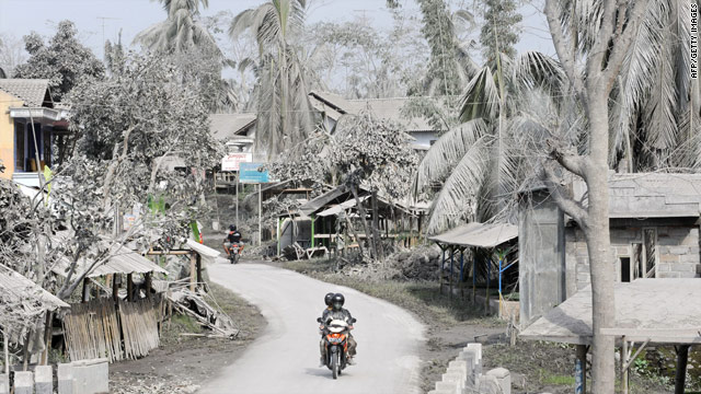 A motorcyclist rides through a village covered with ash from Mount Merapi eruption in central Java on Thursday.