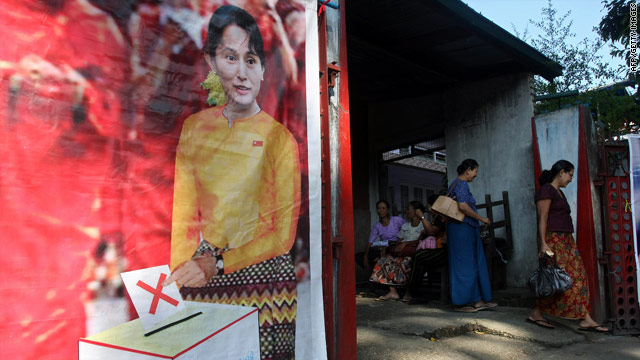 People walk into the National League for Democracy (NLD) office past portraits of Aung San Suu Kyi in Yangon on Nov 4, 2010.