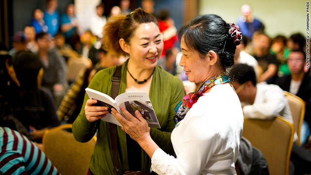 Wu Youjian, right, chats with another parent of gay child at a recent event at Shanghai Pride, a month-long celebration of gay culture in China's largest city.