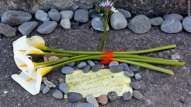 Flowers and a note lay at the foot of the Strongman Mine Memorial on Monday in Greymouth, New Zealand.