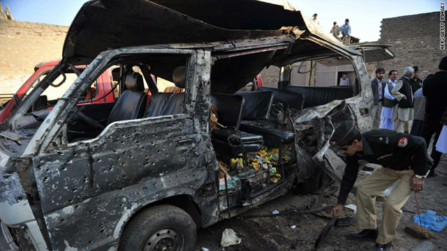 A police officer inspects a van after a suicide bomb attack in Kohat, Pakistan on December 8, 2010.