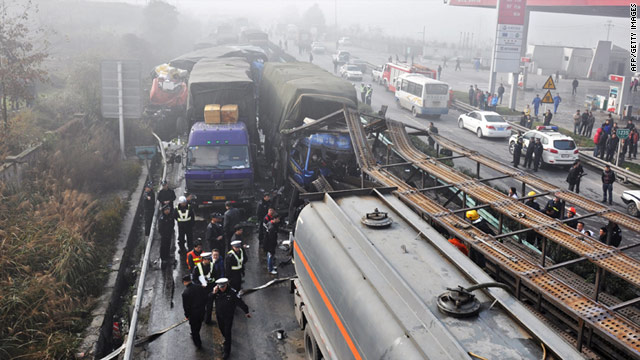 Police block off a road after dozens of vehicles crashed in Zunyi, China, on Monday.