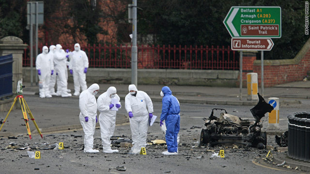 Police forenics experts inspect damage from a car bomb that exploded outside the courthouse in Newry.