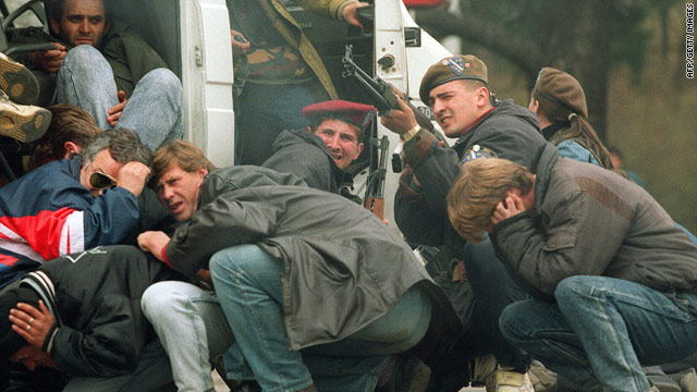 A special forces soldier returns fire in April 1992 in Sarajevo as he and civilians come under fire from Serbian snipers.