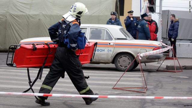 A Russian emergency worker carries a stretcher to the Park Kulturi metro station in Moscow Monday after a suicide attack.