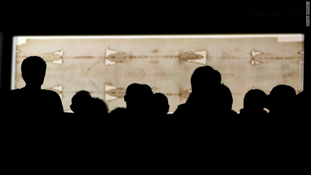 People stand in front of the Holy Shroud during the Solemn Exposition Of The Holy Shroud on April 10, 2010 in Turin, Italy.