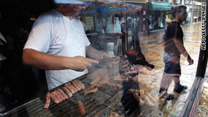 A cook grills meat balls in a restaurant at Skopje's old bazaar.