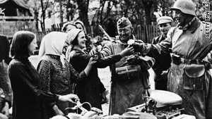 Lithuanians welcome Nazi soldiers with flowers in the summer of 1941.