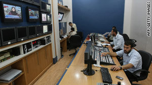 Palestinians work at Hamas-run Al-Aqsa TV in Gaza City on June 15 after Paris decided to take it off the air in France.