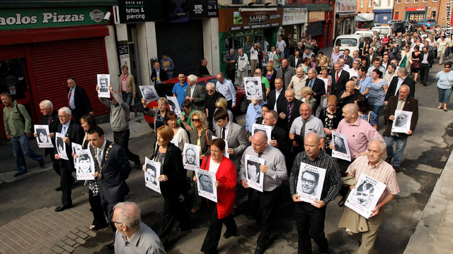 Families of victims of the Bloody Sunday shootings march through Londonderry Tuesday holding photographs of relatives.