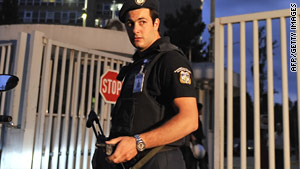 Police guard the entrance to the Ministry of Citizen Protection in Athens, Greece, after Thursday's bombing.