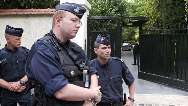 French police guard the entrance of Liliane Bettencourt's home on July 26.