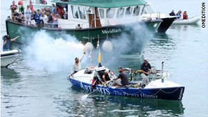 The crew celebrates as it approaches the Isles of Scilly after spending 43 days on the ocean.
