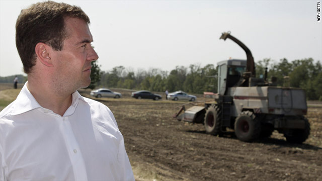 Russian President Dmitry Medvedev walks through a field while touring a farm on August 12, 2010.