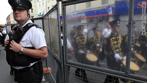 A police officer stands by barriers during the Apprentice Boys march in Londonderry, Northern Ireland, on Saturday.