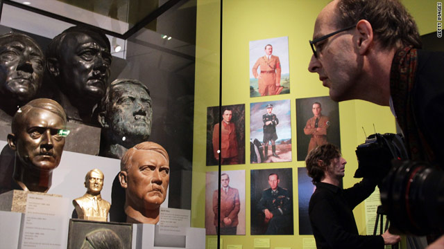 A visitor looks at busts of Adolf Hitler in the "Hitler and the Germans" exhibit at the German Historical Museum.