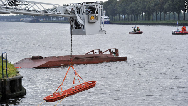Divers search the Amsterdam-Rijn canal on Friday after a collision between a freight ship and a passenger ferry.