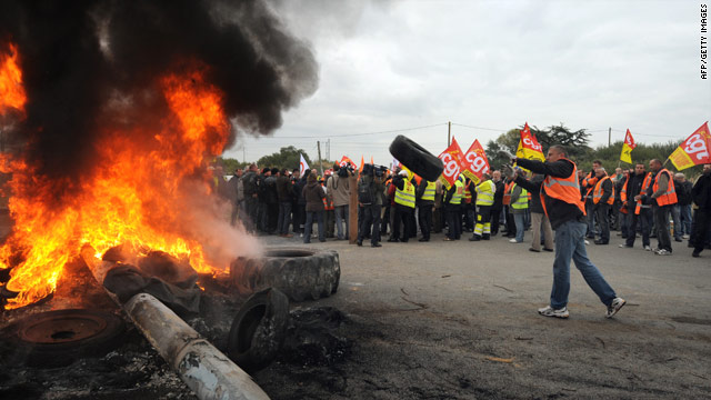 Striking workers burn tires outside the Donges' Total refinery and oil depot on October 15, 2010 in Saint-Nazaire, France.