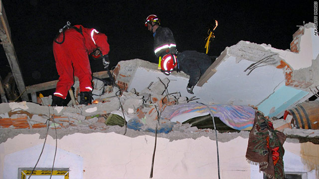 Rescue workers examine the collapsed roof of a building in Kraljevo, in central Serbia, on November 3, 2010.
