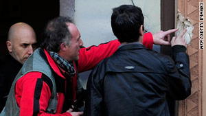 Spanish forensic experts investigate a bullet hole the scene in Barcelona on Wednesday.