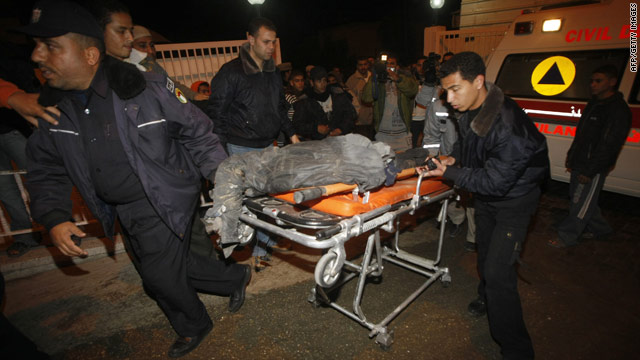 Palestinians wheel a body to a  hospital morgue after Israeli airstrikes hit smuggling tunnels in the Gaza Strip, January 8, 2010.
