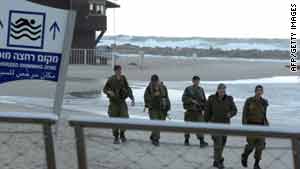 Israeli soldiers patrol a beach in the northern city of Netanya on February 3, 2010.