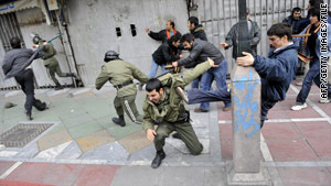 Iranian opposition protesters clash with security forces in Tehran on December 27.