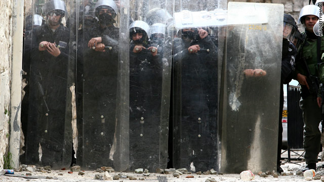 An Israeli police force takes position in an alley during clashes with Palestinian youths in Jerusalem.